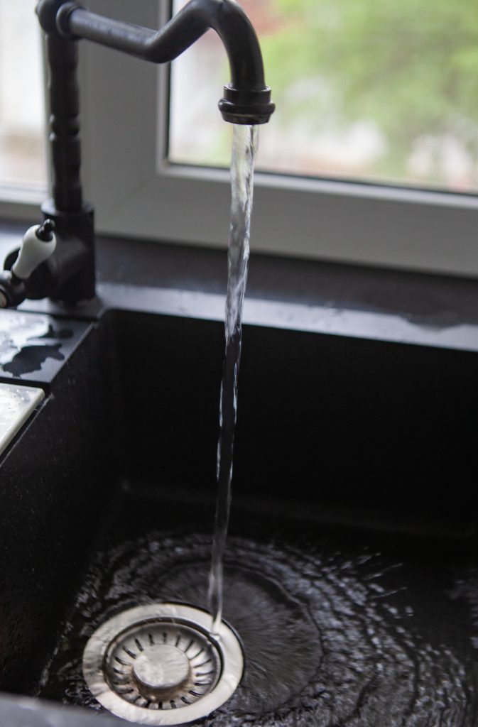 tap water flows into the sink